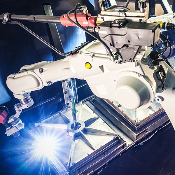 A robotic welding arms in operation.