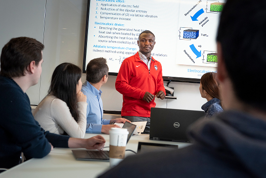 male with red shirt presenting